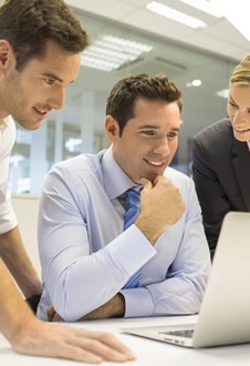 people looking at a laptop screen
